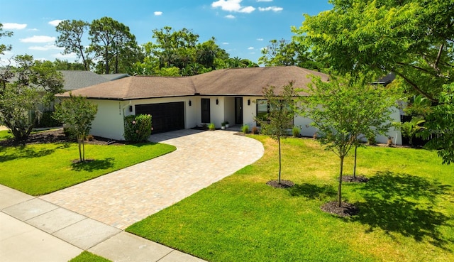 13916 Wellesford Way, Tampa, FL 33624 - single story home with an attached garage, a front lawn, decorative driveway, and stucco siding