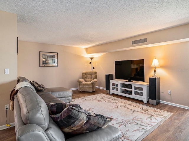 830 S Gulfview Blvd Unit 102, Clearwater Beach, FL 33767 - living room with wood finished floors, baseboards, and a textured ceiling