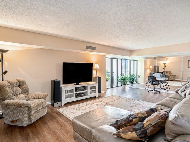 830 S Gulfview Blvd Unit 102, Clearwater Beach, FL 33767 - living area featuring wood finished floors, a textured ceiling, and baseboards