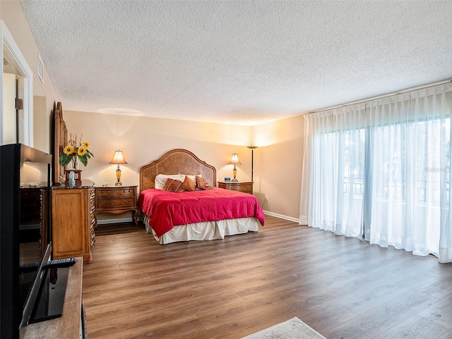 830 S Gulfview Blvd Unit 102, Clearwater Beach, FL 33767 - bedroom featuring a textured ceiling and wood finished floors