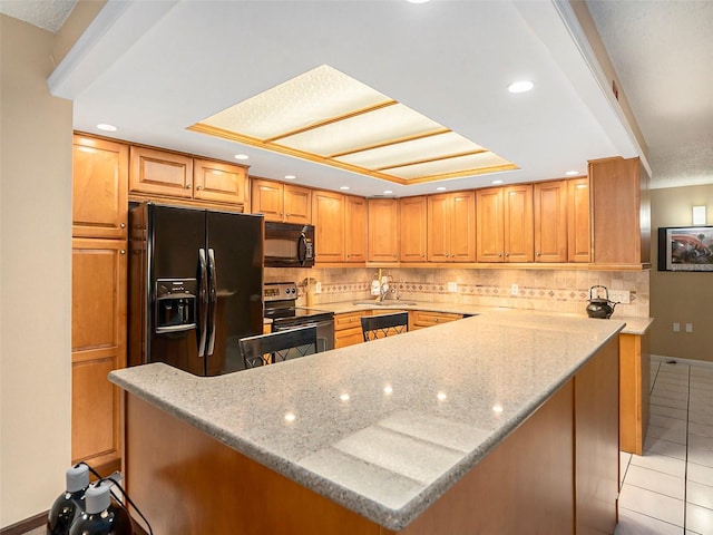 830 S Gulfview Blvd Unit 102, Clearwater Beach, FL 33767 - kitchen with black appliances, a sink, light tile patterned flooring, decorative backsplash, and light stone counters