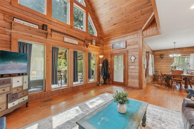 5817 Myrtle Ln, Tampa, FL 33625 - living room with wood-type flooring, high vaulted ceiling, wood walls, a chandelier, and wooden ceiling
