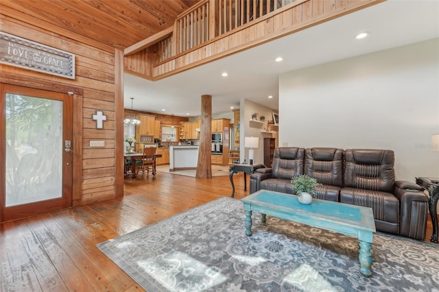 5817 Myrtle Ln, Tampa, FL 33625 - living area featuring light wood-type flooring, recessed lighting, and wood walls