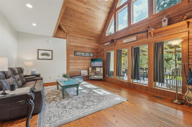 5817 Myrtle Ln, Tampa, FL 33625 - living room with high vaulted ceiling, wood walls, wood-type flooring, wood ceiling, and recessed lighting