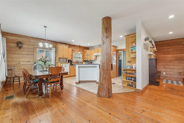 5817 Myrtle Ln, Tampa, FL 33625 - dining area featuring light wood-style floors, recessed lighting, wooden walls, and a chandelier