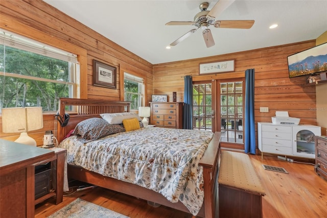 5817 Myrtle Ln, Tampa, FL 33625 - bedroom featuring wood finished floors, wood walls, recessed lighting, and access to exterior