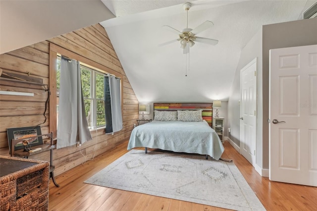 5817 Myrtle Ln, Tampa, FL 33625 - bedroom featuring vaulted ceiling, wooden walls, wood-type flooring, and a ceiling fan