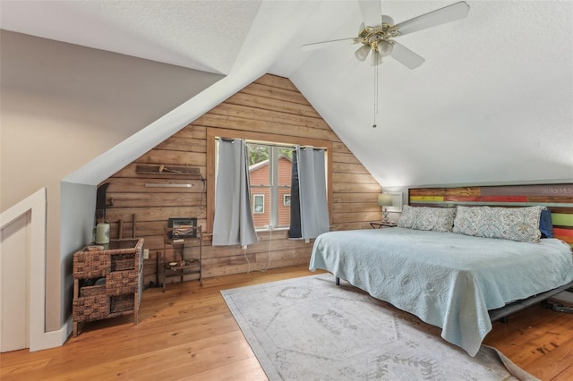 5817 Myrtle Ln, Tampa, FL 33625 - bedroom featuring wood walls, hardwood / wood-style flooring, lofted ceiling, and ceiling fan