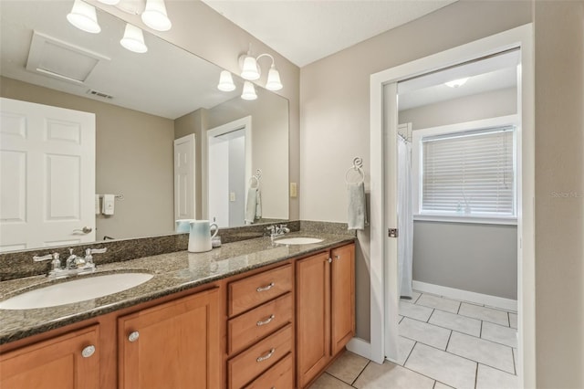 5817 Myrtle Ln, Tampa, FL 33625 - full bath featuring tile patterned flooring, double vanity, and baseboards