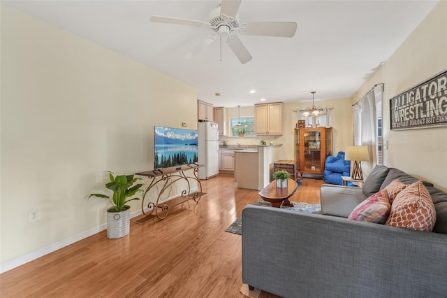 5817 Myrtle Ln, Tampa, FL 33625 - living area featuring light wood finished floors, ceiling fan, baseboards, a chandelier, and recessed lighting