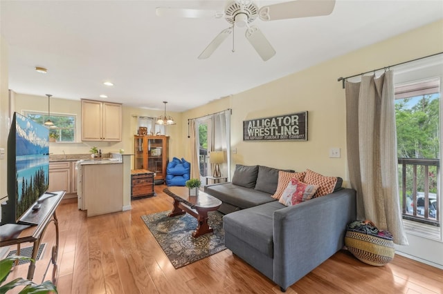 5817 Myrtle Ln, Tampa, FL 33625 - living room featuring healthy amount of natural light, light wood-type flooring, ceiling fan, and recessed lighting