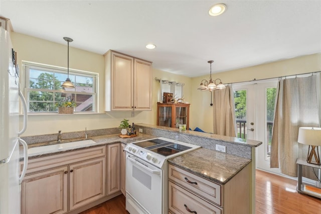 5817 Myrtle Ln, Tampa, FL 33625 - kitchen with white appliances, a peninsula, plenty of natural light, a sink, and recessed lighting