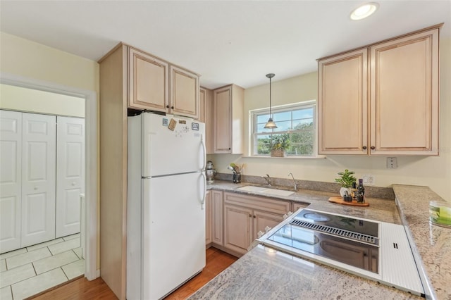 5817 Myrtle Ln, Tampa, FL 33625 - kitchen featuring freestanding refrigerator, a sink, light brown cabinets, and recessed lighting