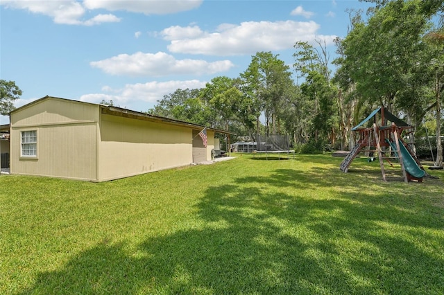 5817 Myrtle Ln, Tampa, FL 33625 - view of green lawn with a trampoline and a playground