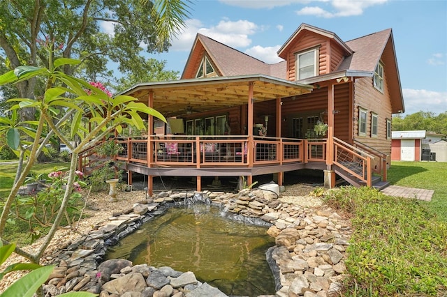 5817 Myrtle Ln, Tampa, FL 33625 - rear view of house with a wooden deck, ceiling fan, roof with shingles, and log veneer siding