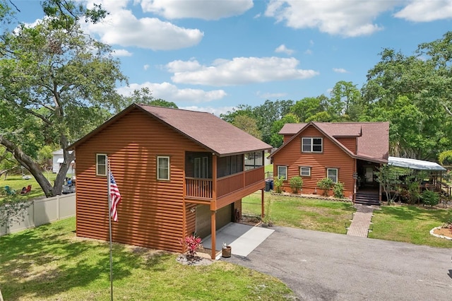 5817 Myrtle Ln, Tampa, FL 33625 - view of front of property with asphalt driveway, log veneer siding, roof with shingles, and a garage