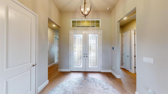 426 Bourganville Dr, Palm Coast, FL 32137 - entryway featuring french doors, light wood finished floors, and baseboards