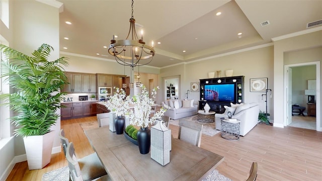 426 Bourganville Dr, Palm Coast, FL 32137 - dining space featuring a chandelier, light wood-style floors, recessed lighting, baseboards, and ornamental molding