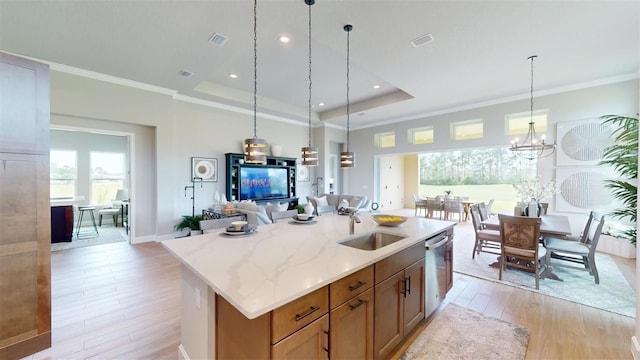 426 Bourganville Dr, Palm Coast, FL 32137 - kitchen with light wood finished floors, open floor plan, a sink, decorative light fixtures, and a kitchen island with sink