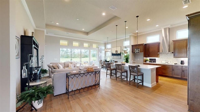 426 Bourganville Dr, Palm Coast, FL 32137 - living room featuring light wood-type flooring, recessed lighting, plenty of natural light, ornamental molding, and a towering ceiling