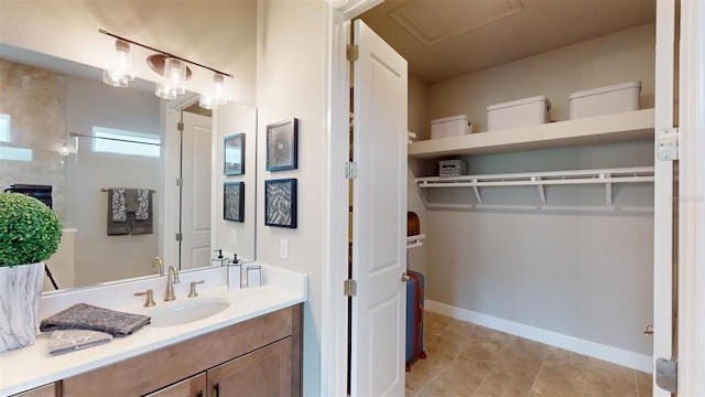 426 Bourganville Dr, Palm Coast, FL 32137 - bathroom with vanity, baseboards, and a walk in closet