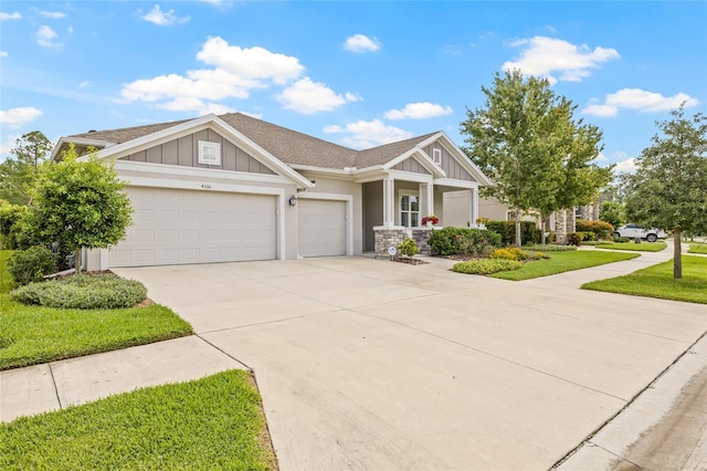 4166 Epic Cv, Land O Lakes, FL 34638 - craftsman-style house featuring an attached garage, concrete driveway, a front yard, board and batten siding, and a shingled roof