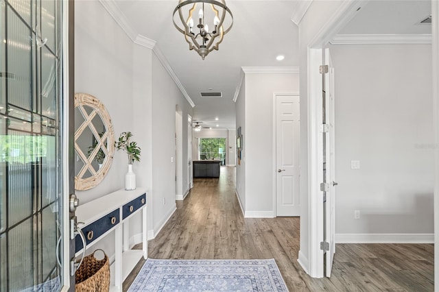 4166 Epic Cv, Land O Lakes, FL 34638 - entrance foyer featuring wood finished floors, a chandelier, baseboards, crown molding, and ceiling fan