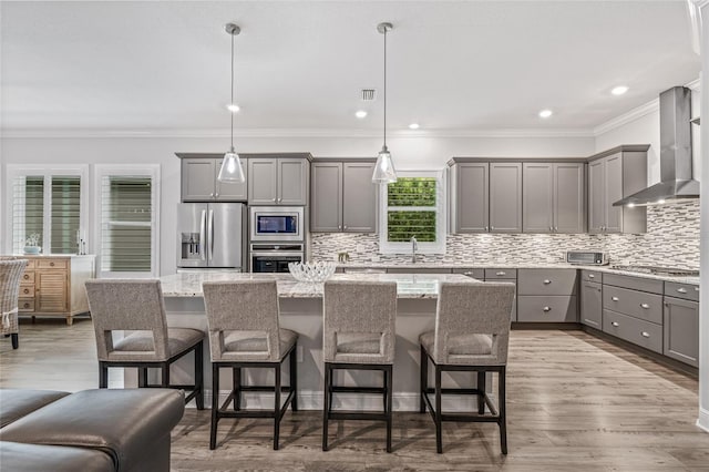 4166 Epic Cv, Land O Lakes, FL 34638 - kitchen with stainless steel appliances, gray cabinets, wall chimney exhaust hood, a kitchen island, and backsplash