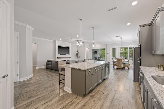 4166 Epic Cv, Land O Lakes, FL 34638 - kitchen featuring gray cabinetry, open floor plan, ornamental molding, light wood-style floors, and recessed lighting