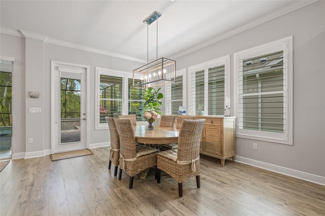 4166 Epic Cv, Land O Lakes, FL 34638 - dining room with crown molding, a chandelier, light wood-style flooring, and baseboards