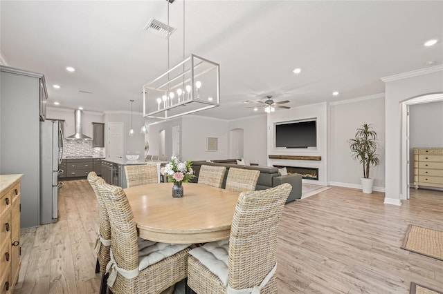 4166 Epic Cv, Land O Lakes, FL 34638 - dining space featuring arched walkways, recessed lighting, ornamental molding, a ceiling fan, and light wood-style flooring