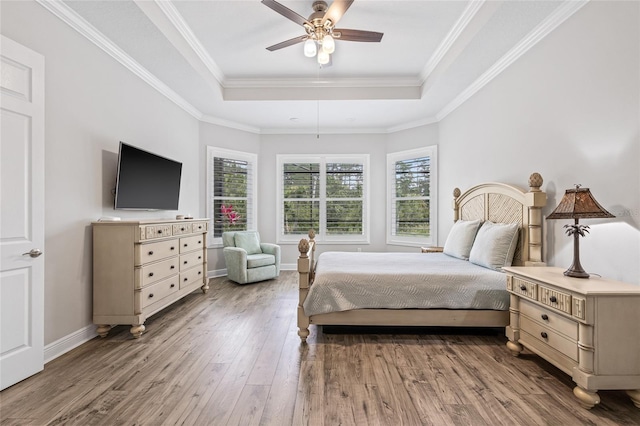 4166 Epic Cv, Land O Lakes, FL 34638 - bedroom featuring a raised ceiling, hardwood / wood-style flooring, baseboards, a ceiling fan, and ornamental molding