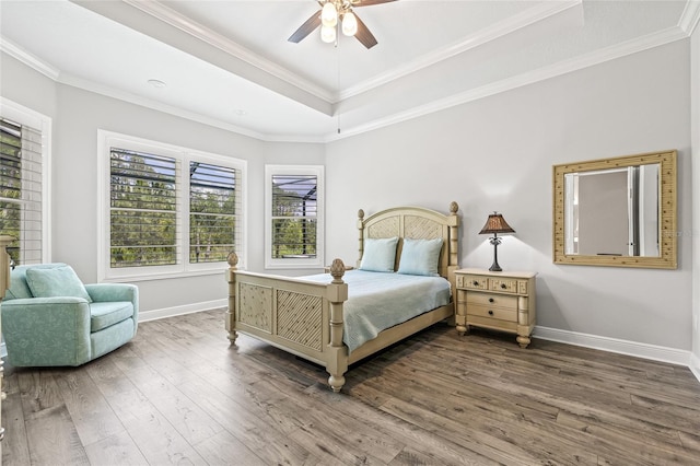 4166 Epic Cv, Land O Lakes, FL 34638 - bedroom featuring multiple windows, wood finished floors, a tray ceiling, and crown molding