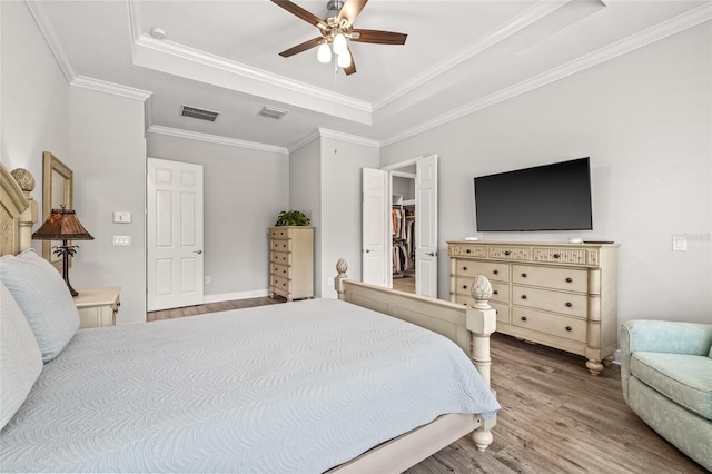 4166 Epic Cv, Land O Lakes, FL 34638 - bedroom with a raised ceiling, wood finished floors, ornamental molding, and a ceiling fan