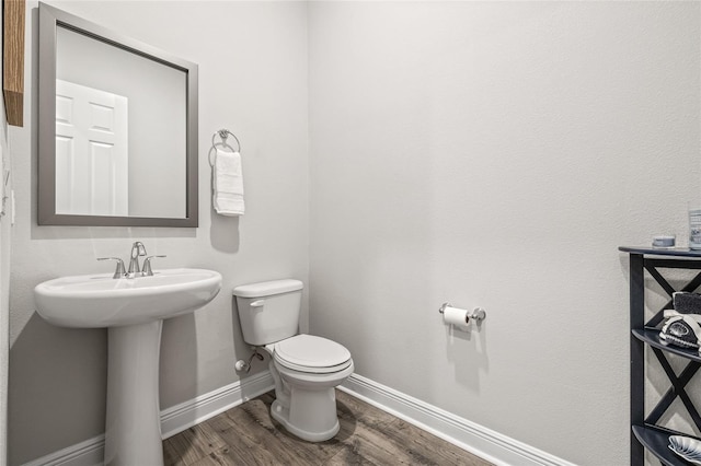 4166 Epic Cv, Land O Lakes, FL 34638 - half bath featuring toilet, wood finished floors, baseboards, and a sink
