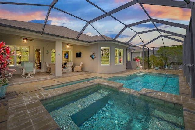 4166 Epic Cv, Land O Lakes, FL 34638 - pool at dusk featuring a pool with connected hot tub, a patio area, and a ceiling fan