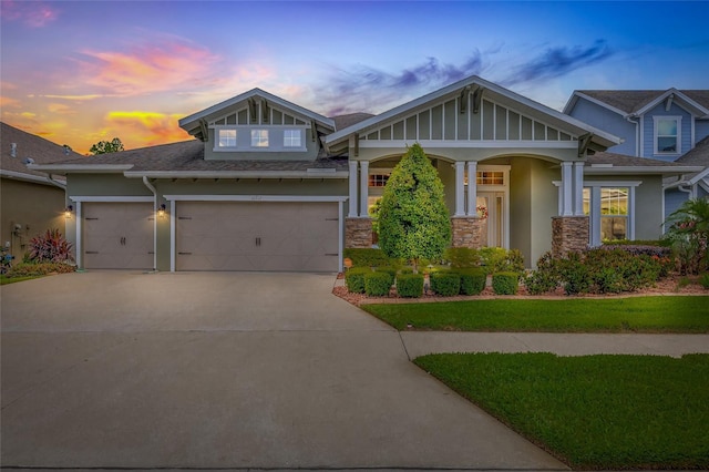 16712 Courtyard Loop, Land O Lakes, FL 34638 - craftsman-style house featuring stucco siding, driveway, stone siding, and a shingled roof