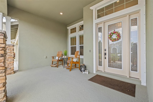 16712 Courtyard Loop, Land O Lakes, FL 34638 - property entrance with stucco siding and a porch