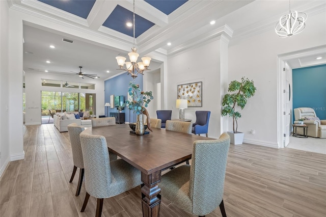 16712 Courtyard Loop, Land O Lakes, FL 34638 - dining room with a chandelier, baseboards, crown molding, a ceiling fan, and light wood-style floors