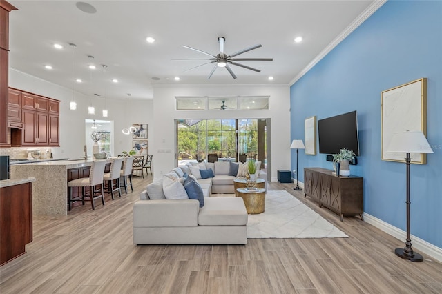 16712 Courtyard Loop, Land O Lakes, FL 34638 - living room with a ceiling fan, light wood-style floors, crown molding, recessed lighting, and baseboards