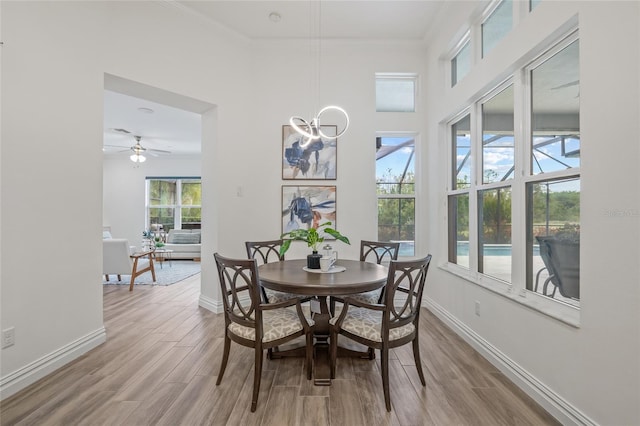 16712 Courtyard Loop, Land O Lakes, FL 34638 - dining space with baseboards, wood finished floors, ornamental molding, a towering ceiling, and ceiling fan