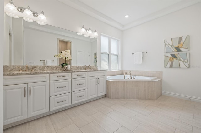 16712 Courtyard Loop, Land O Lakes, FL 34638 - bathroom featuring double vanity and a bath