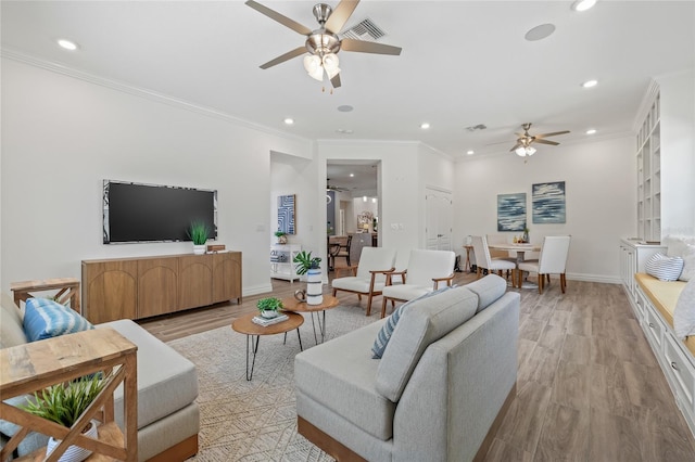 16712 Courtyard Loop, Land O Lakes, FL 34638 - living area featuring a ceiling fan, recessed lighting, light wood finished floors, crown molding, and baseboards