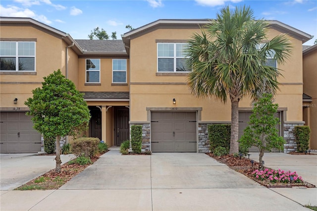 14110 Damselfly Dr, Tampa, FL 33625 - multi unit property with stucco siding, driveway, a garage, and stone siding