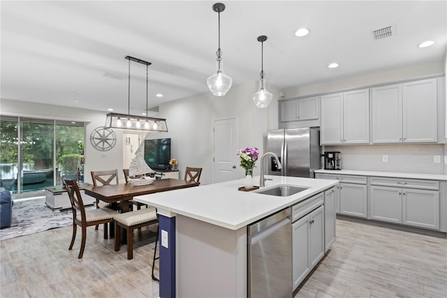 14110 Damselfly Dr, Tampa, FL 33625 - kitchen with stainless steel appliances, a sink, light countertops, an island with sink, and recessed lighting