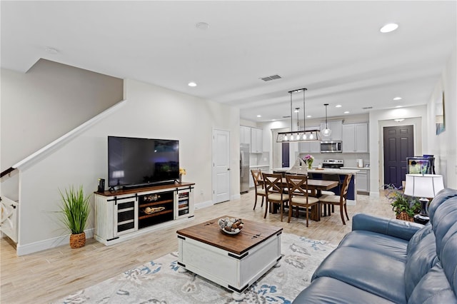 14110 Damselfly Dr, Tampa, FL 33625 - living room featuring baseboards, recessed lighting, and light wood-type flooring