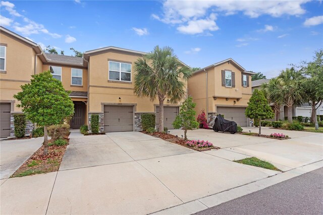 14110 Damselfly Dr, Tampa, FL 33625 - multi unit property with stucco siding, driveway, a garage, and stone siding