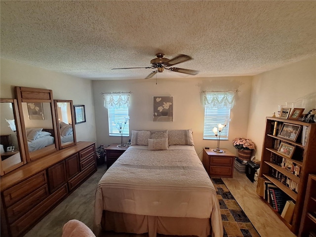bedroom with a textured ceiling and a ceiling fan