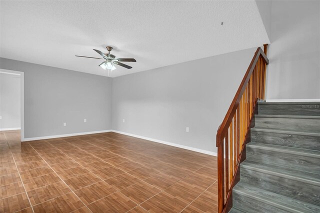 714 1st Ct, Palm Harbor, FL 34684 - stairs featuring ceiling fan, a textured ceiling, and baseboards