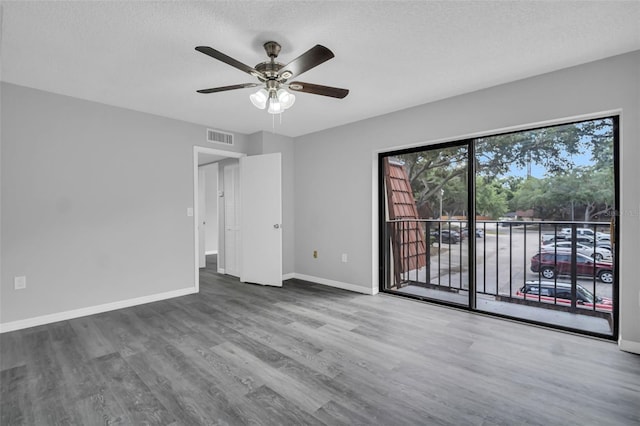 714 1st Ct, Palm Harbor, FL 34684 - spare room featuring a ceiling fan, wood finished floors, baseboards, and a textured ceiling